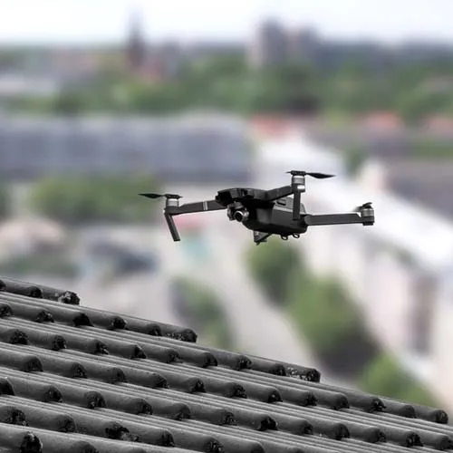 Drone in the air inspecting the roof over the house. Close-up of drone and roof.